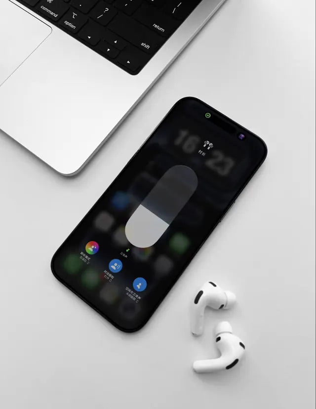 DOGDAD TECH earbuds beside a laptop and phone